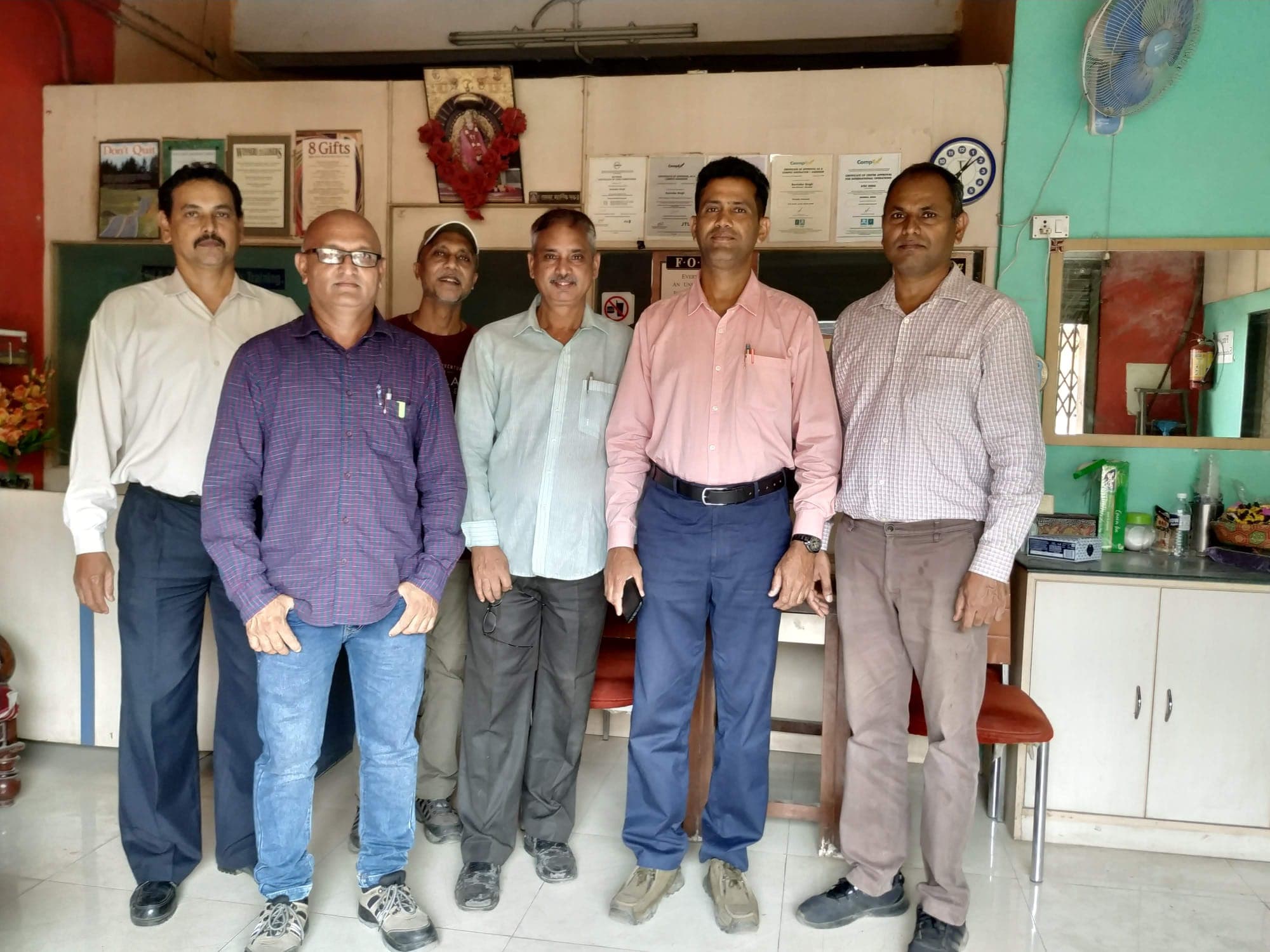 Six engineers with their trainer standing together in the centre's reception at the end of a course.